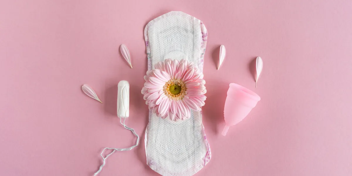 menstruation period concept hygienic white female pad, menstrual cup and tampon with pink flowers menstruation, protection women's health menstruation period concept hygienic white female pad, menstrual cup and tampon with pink flowers menstruation, protection women's health