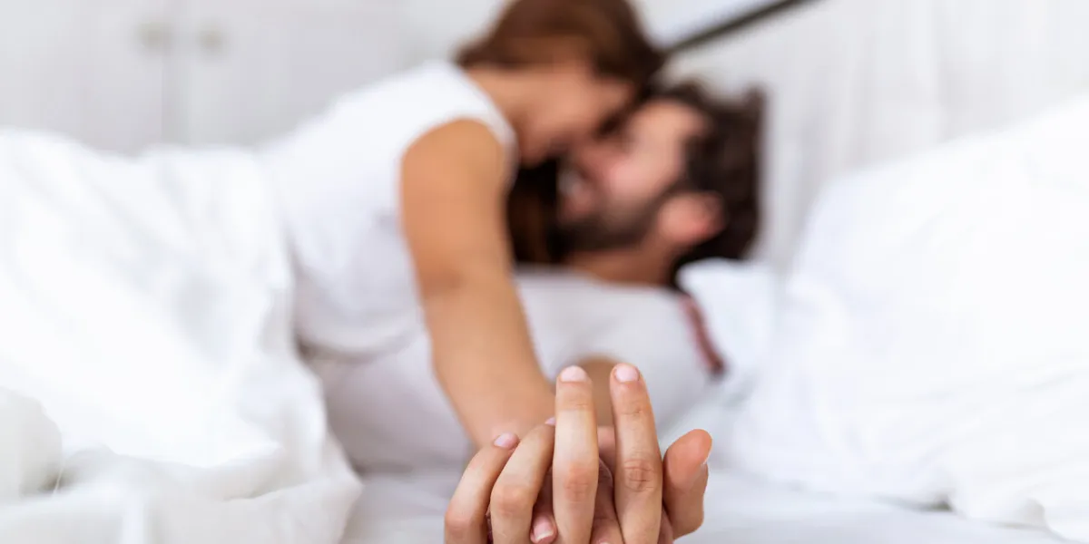 romantic couple in bed enjoying sensual foreplay focus on hands man and woman happy sensual young couple lying in bed together beautiful loving couple kissing in bed romantic couple in bed enjoying sensual foreplay focus on hands man and woman happy sensual young couple lying in bed together beautiful loving couple kissing in bed