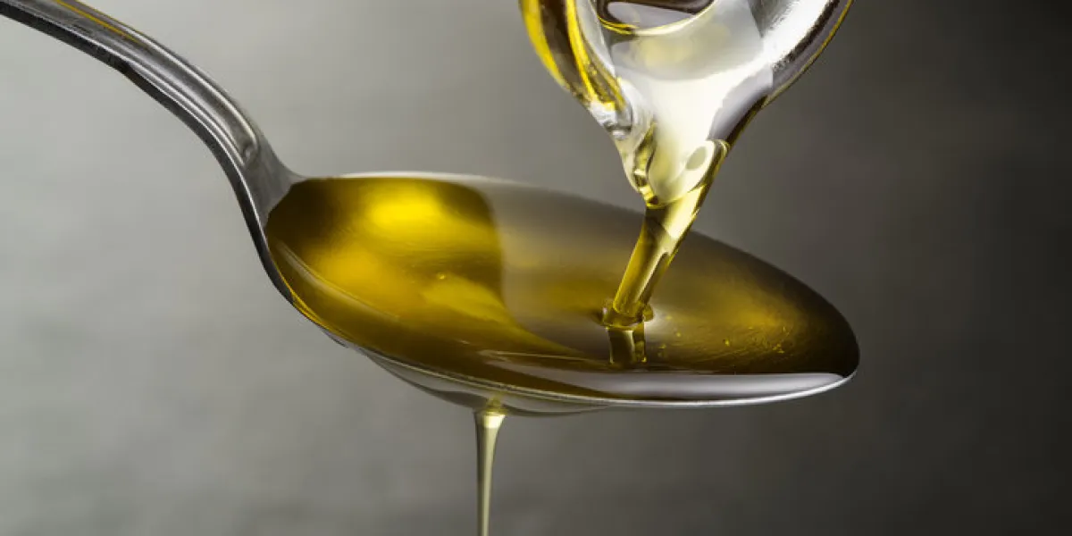 oil pouring and dripping to the spoon close up oil pouring and dripping to the spoon close up