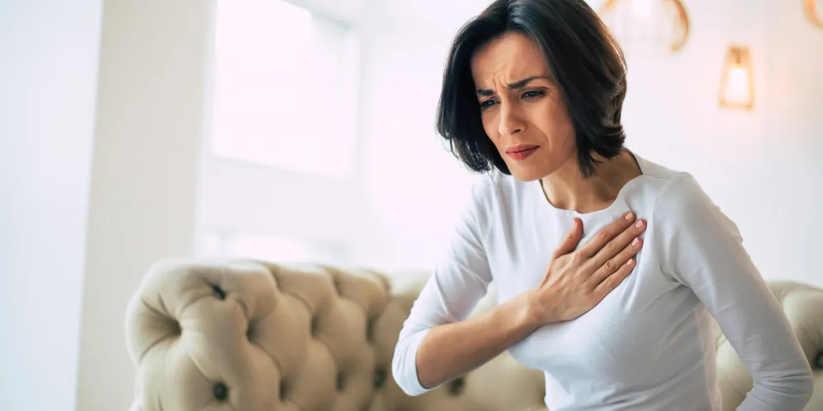 pressure in the chest close-up photo of a stressed woman who is suffering from a chest pain and touching her heart area pressure in the chest close-up photo of a stressed woman who is suffering from a chest pain and touching her heart area