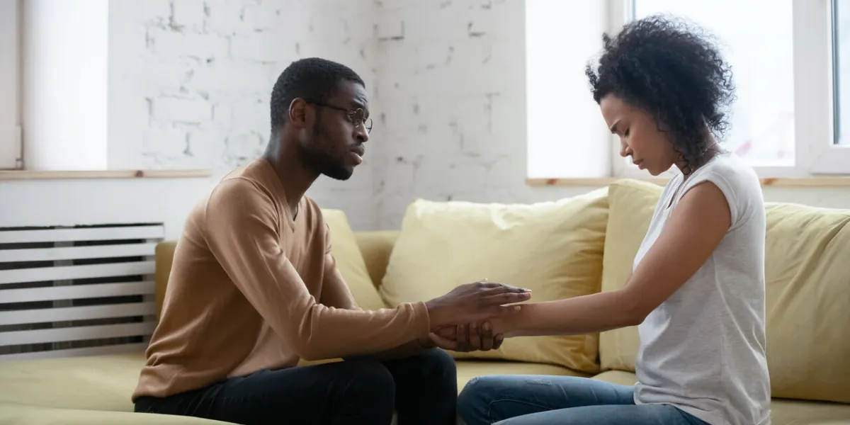 care african american man comforting upset depressed woman holding wife hand for supporting frustrated disappointed girlfriend having life problem, showing love and support care african american man comforting upset depressed woman holding wife hand for supporting frustrated disappointed girlfriend having life problem, showing love and support