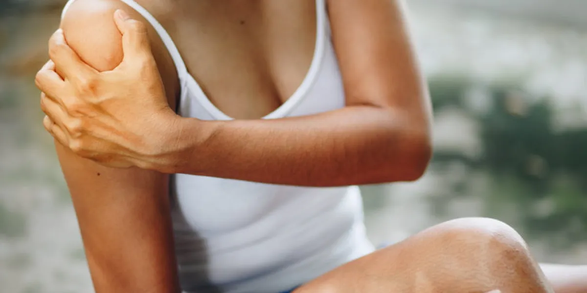 woman with pain in shoulder and upper arm , health care concept