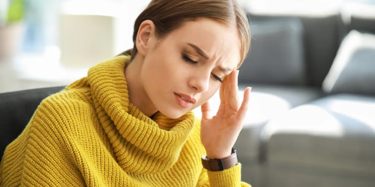 young woman suffering from headache at home young woman suffering from headache at home