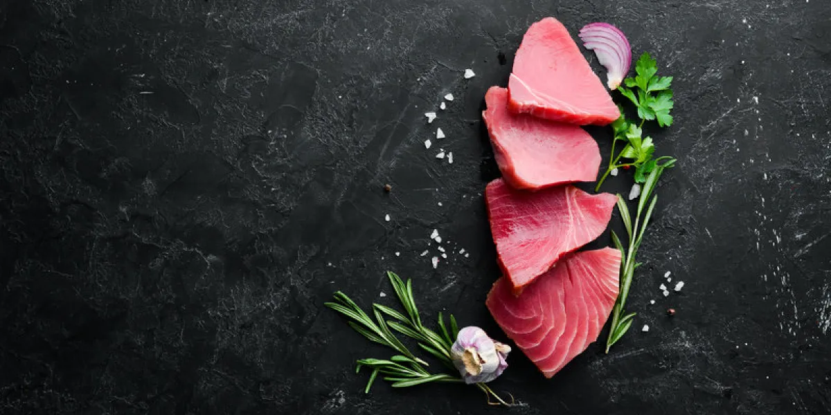 raw tuna fillet seafood on a black stone background top view free copy space raw tuna fillet seafood on a black stone background top view free copy space