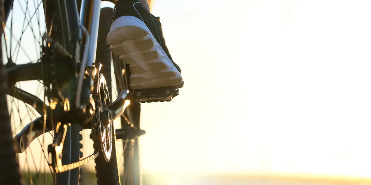 male cyclist riding bicycle outdoors, closeup