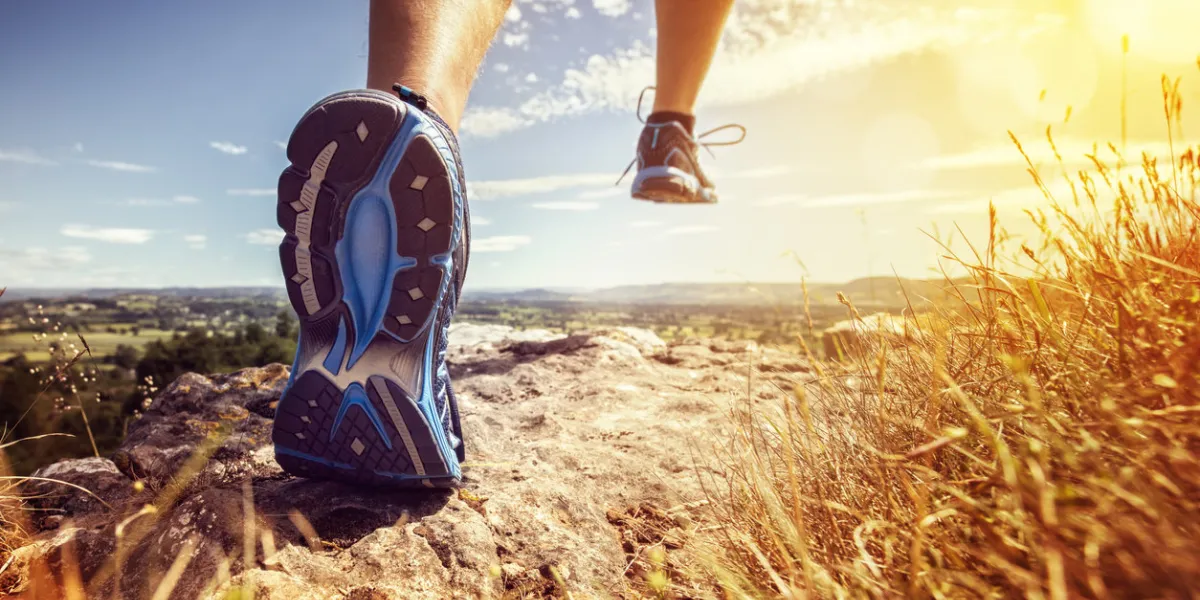 outdoor cross-country running in summer sunshine concept for exercising, fitness and healthy lifestyle