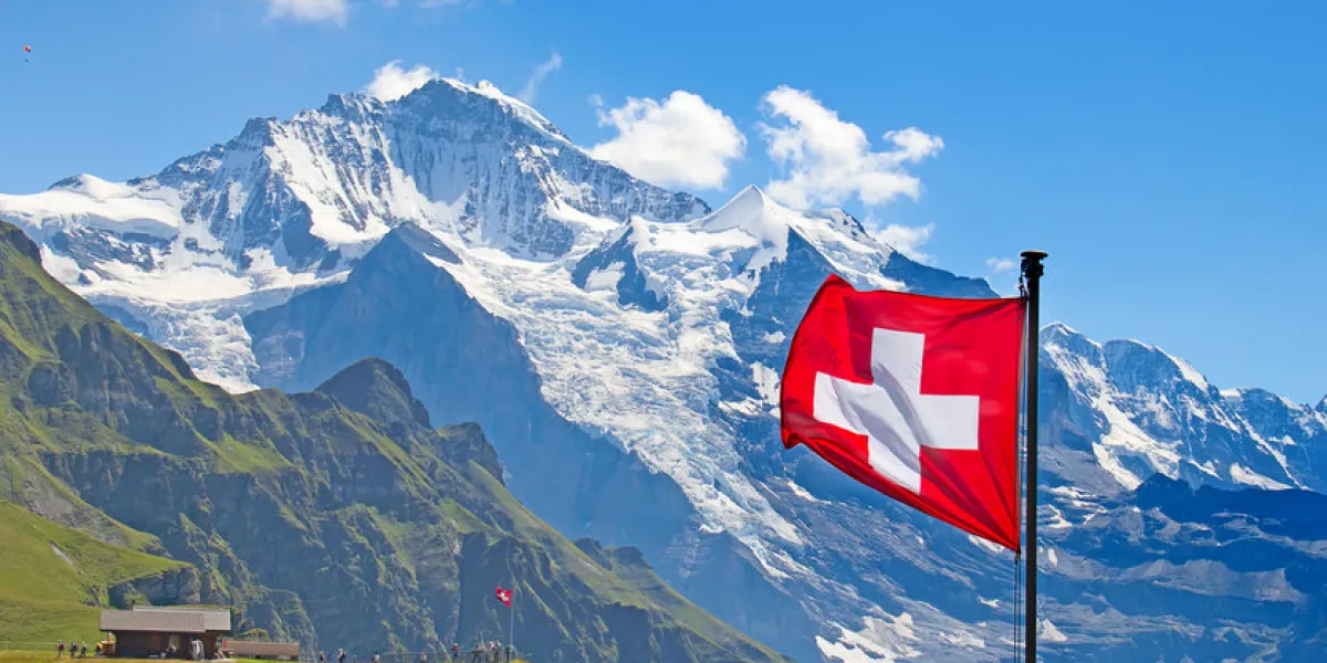 swiss flag on the top of mannlichen (jungfrau region, bern, switzerland) swiss flag on the top of mannlichen (jungfrau region, bern, switzerland)