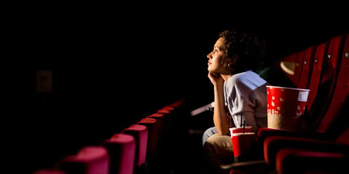 young woman enjoying watching movie at the cinema young woman enjoying watching movie at the cinema