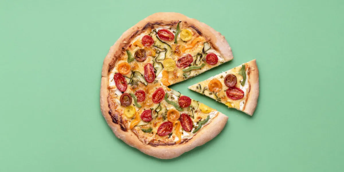 vegetarian pizza on a green background pizza primavera and just one slice single slice of spring pizza italian meal cherry tomato pizza