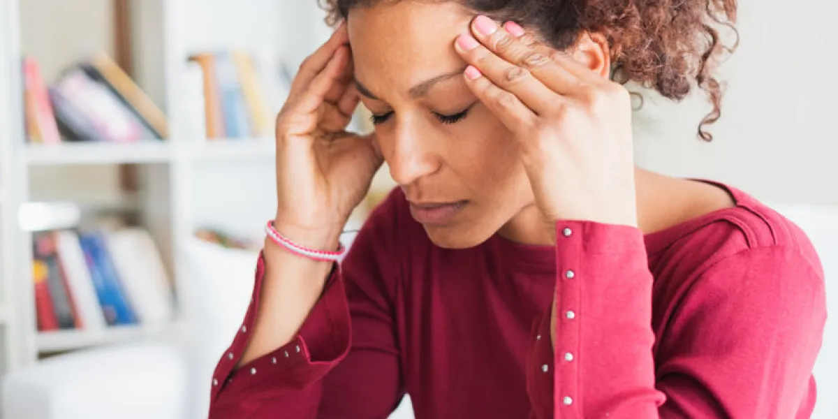 woman suffering from terrible headache massaging temples woman suffering from terrible headache massaging temples