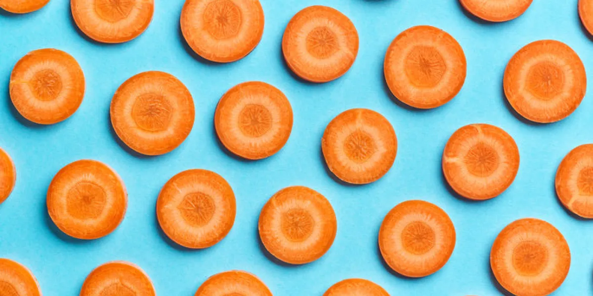 sliced carrot on blue color background sliced carrot on blue color background