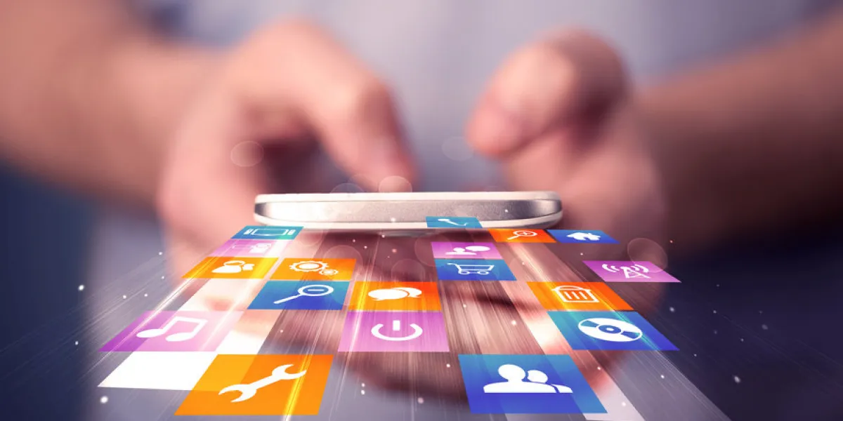 man holding smart phone with colorful application icons comming out man holding smart phone with colorful application icons comming out