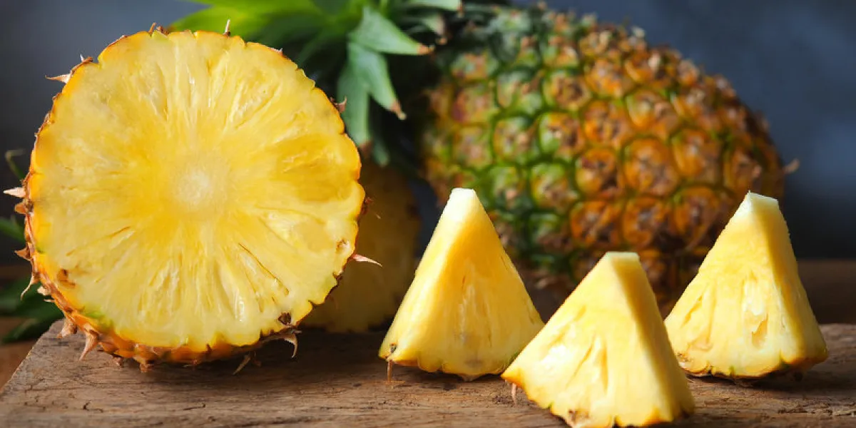 ripe pineapple fruit cut in half and triangle shape on rustic wooden table for high fiber fruits concept ripe pineapple fruit cut in half and triangle shape on rustic wooden table for high fiber fruits concept