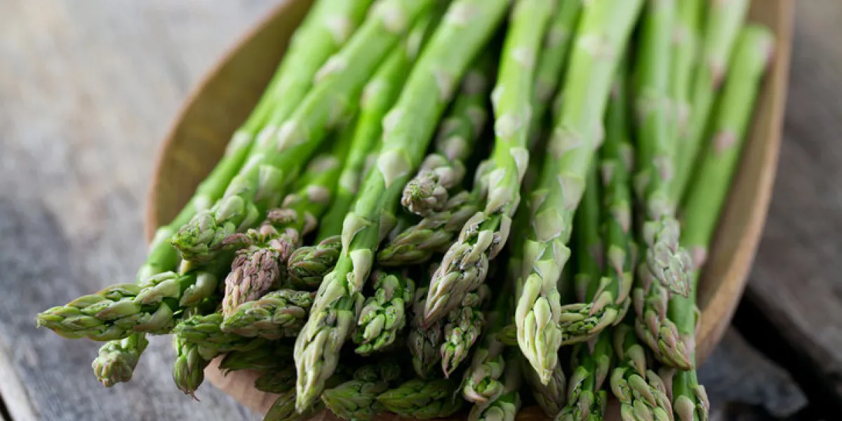 asparagus on wooden surface asparagus on wooden surface