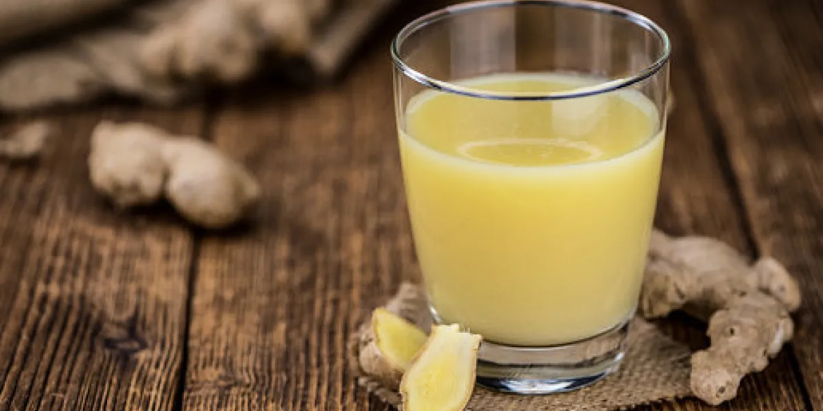 healthy ginger sap on a wooden table as detailed close-up shot (selective focus) healthy ginger sap on a wooden table as detailed close-up shot (selective focus)