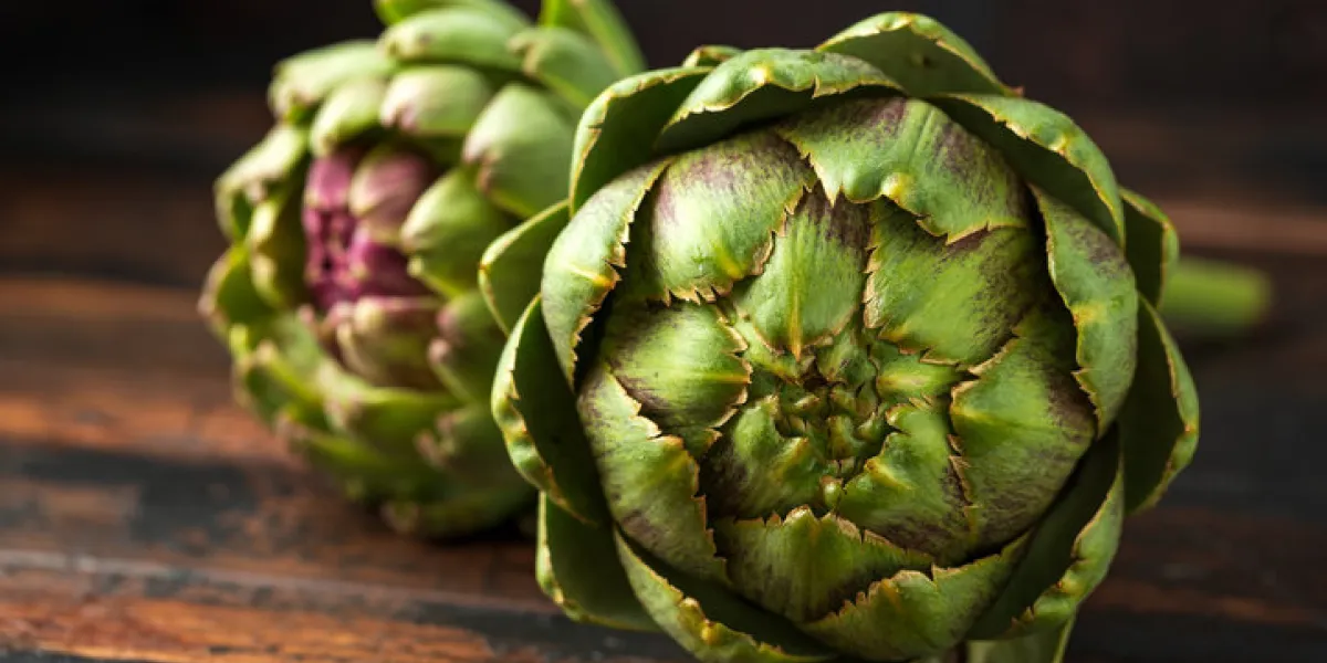 fresh raw organically grown artichoke flower buds on wooden table fresh raw organically grown artichoke flower buds on wooden table