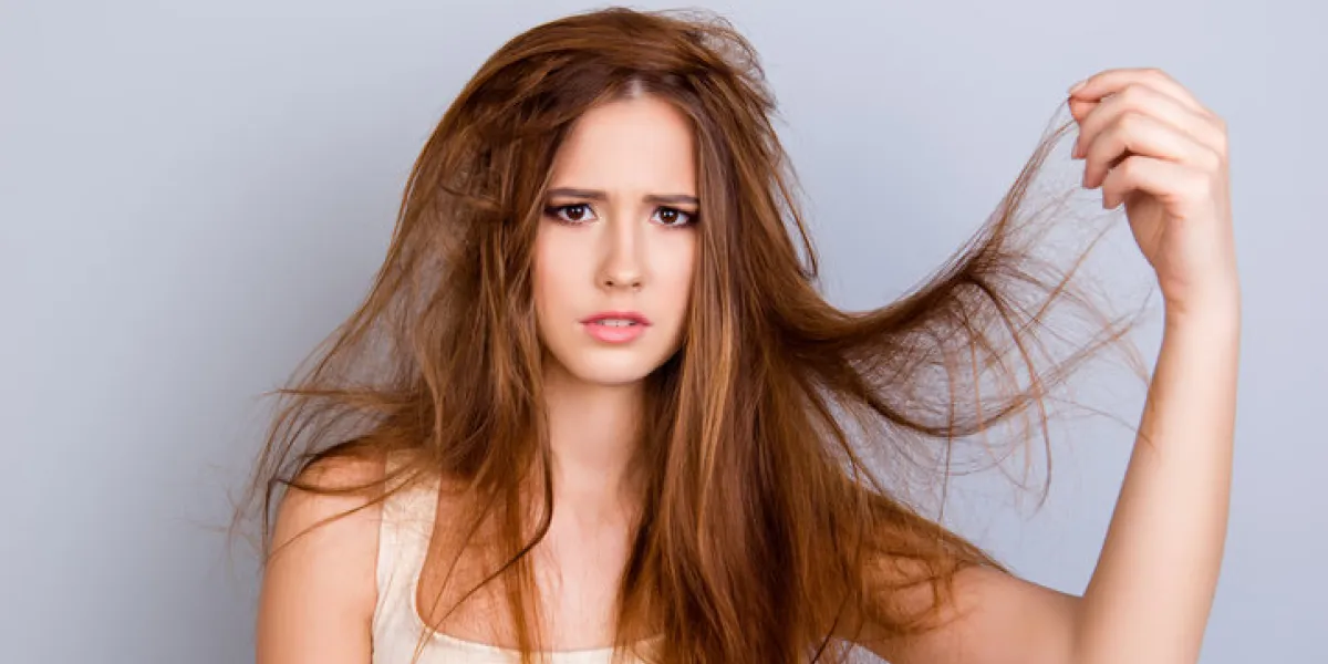 close up portrait of frustrated young girl with messed hair on pure background, wearing white casual singlet, holding her hair close up portrait of frustrated young girl with messed hair on pure background, wearing white casual singlet, holding her hair