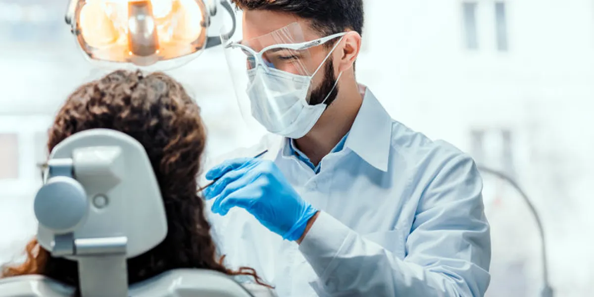 dentist working in dental clinic with patient in the chair dentist working in dental clinic with patient in the chair
