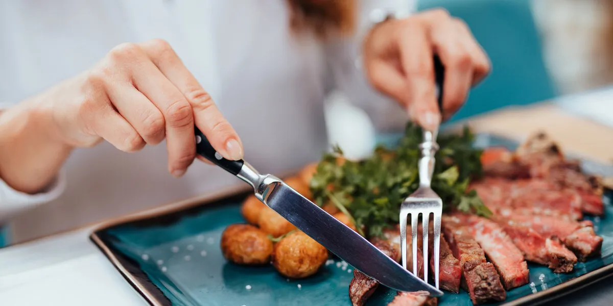 young beautiful and happy woman enjoying in delicious meal in luxurious restaurant