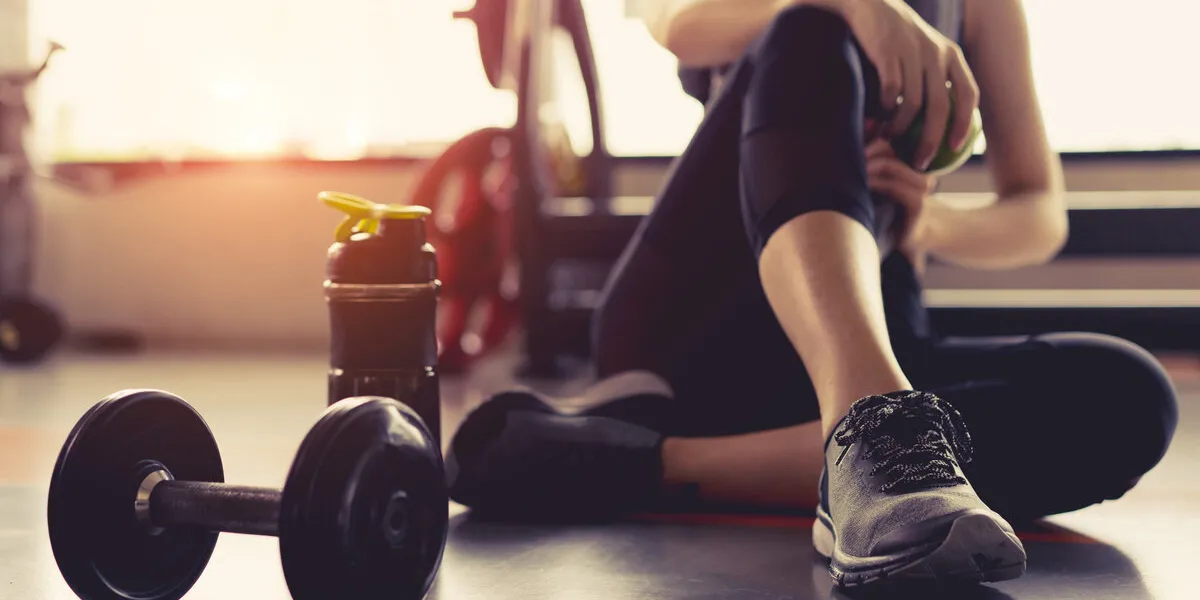 woman exercise workout in gym fitness breaking relax holding apple fruit after training sport with dumbbell and protein shake bottle healthy lifestyle bodybuilding woman exercise workout in gym fitness breaking relax holding apple fruit after training sport with dumbbell and protein shake bottle healthy lifestyle bodybuilding