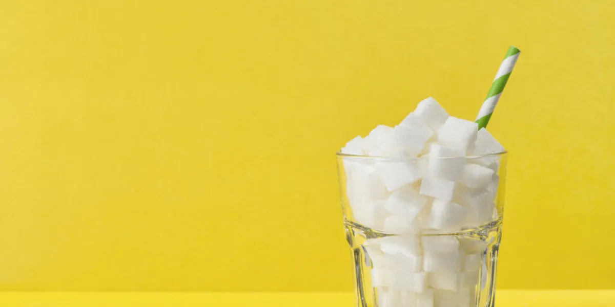 glass with sugar cubes weight control, diet, health and detox concept