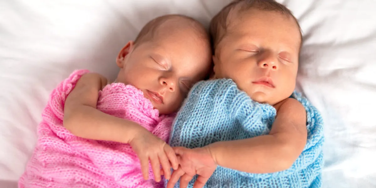 newborn twins sleeping in cuddle together newborn twins sleeping in cuddle together