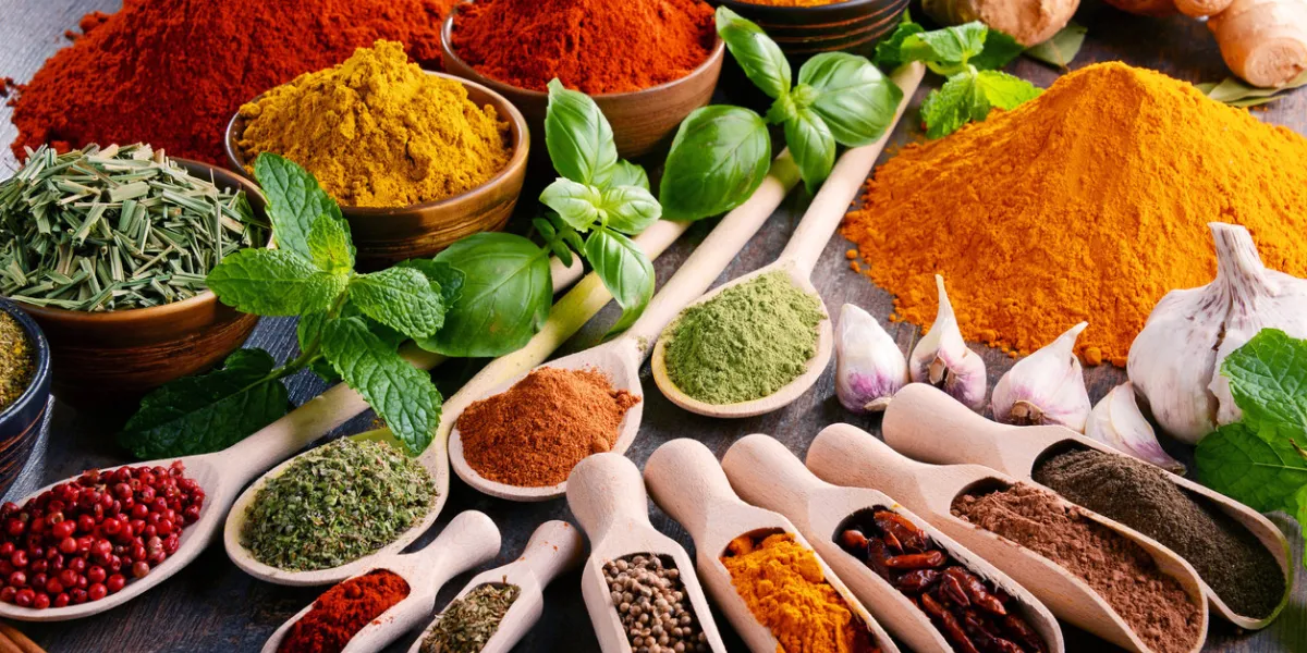 variety of spices and herbs on kitchen table variety of spices and herbs on kitchen table