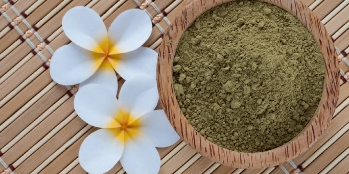 henna powder in coconut bowl on the bamboo mat