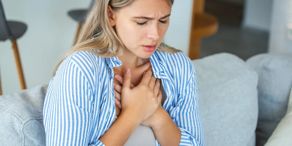 young woman having chestpain,acute pain, possible heart attackeffect of stress and unhealthy lifestyle concept young woman having chestpain,acute pain, possible heart attackeffect of stress and unhealthy lifestyle concept