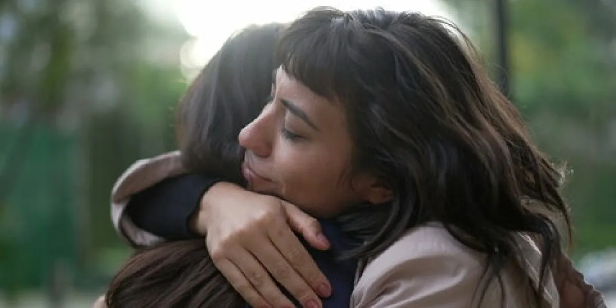 sympathetic woman hugging friend with empathy and support friendship concept between two best friends