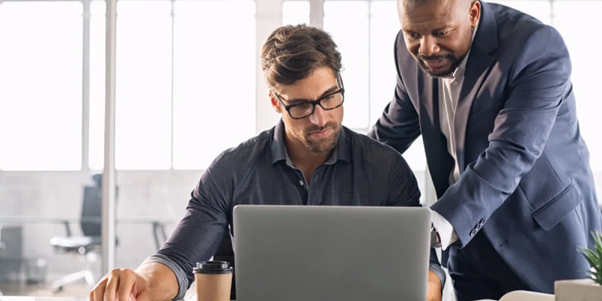 business multiethnic colleagues having meeting in modern office smart business partners planning work together young businessman with boss working together on laptop business multiethnic colleagues having meeting in modern office smart business partners planning work together young businessman with boss working together on laptop