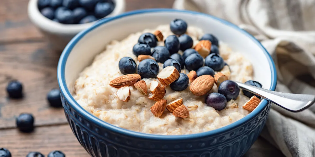 oatmeal porridge with blueberries and almonds healthy breakfast porridge oats on a wooden table closeup view clean eating food oatmeal porridge with blueberries and almonds healthy breakfast porridge oats on a wooden table closeup view clean eating food