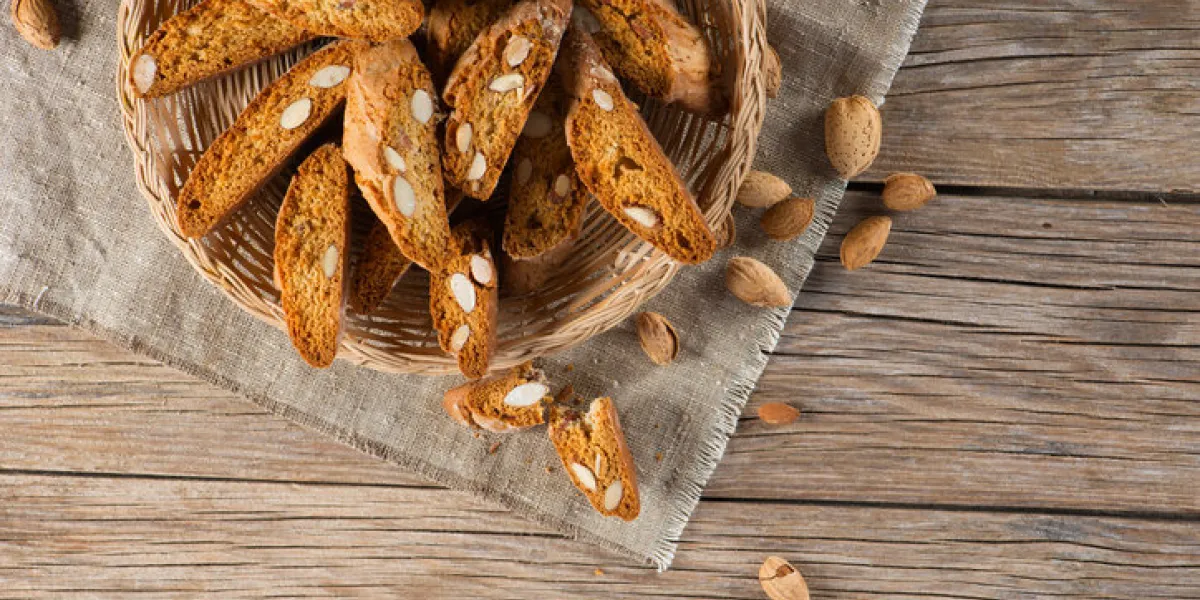 top view of typical tuscan biscuits biscotti with almond in a plate on wooden background top view of typical tuscan biscuits biscotti with almond in a plate on wooden background
