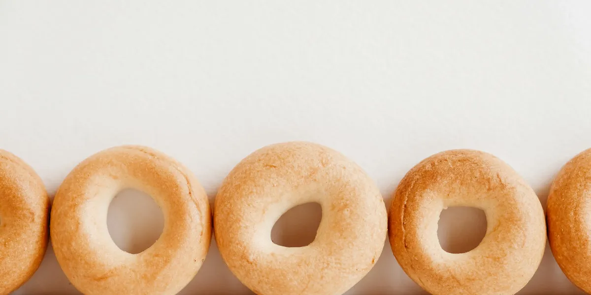 drying or mini round bagels on a white wooden background copy, empty space for text drying or mini round bagels on a white wooden background copy, empty space for text