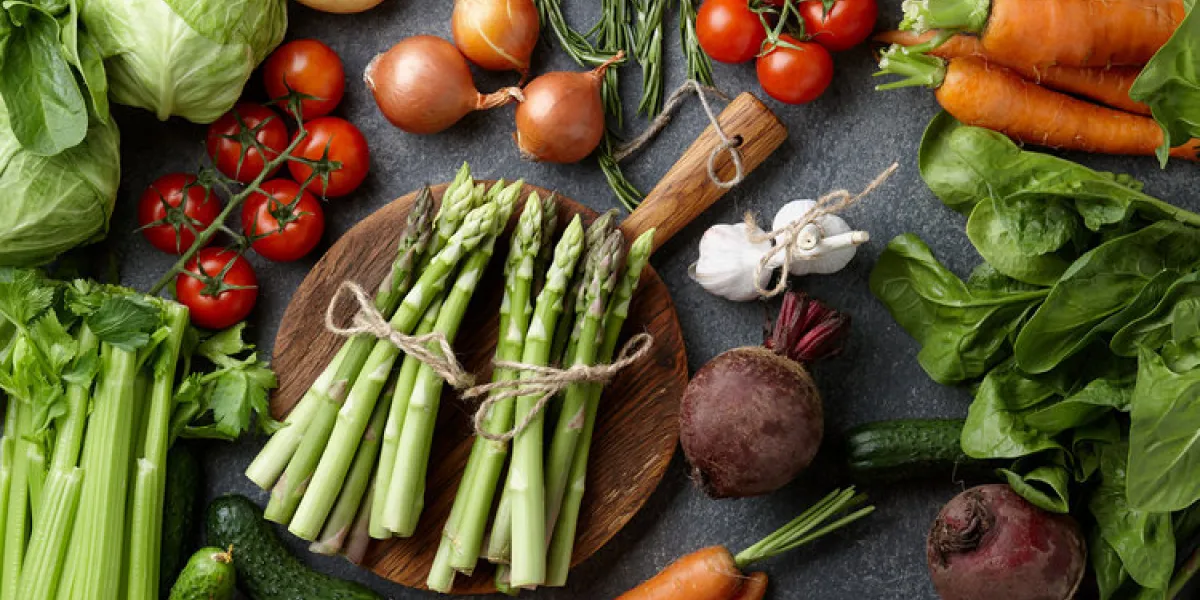 fresh raw asparagus and other spring vegetables cooking in the kitchen, top view fresh raw asparagus and other spring vegetables cooking in the kitchen, top view