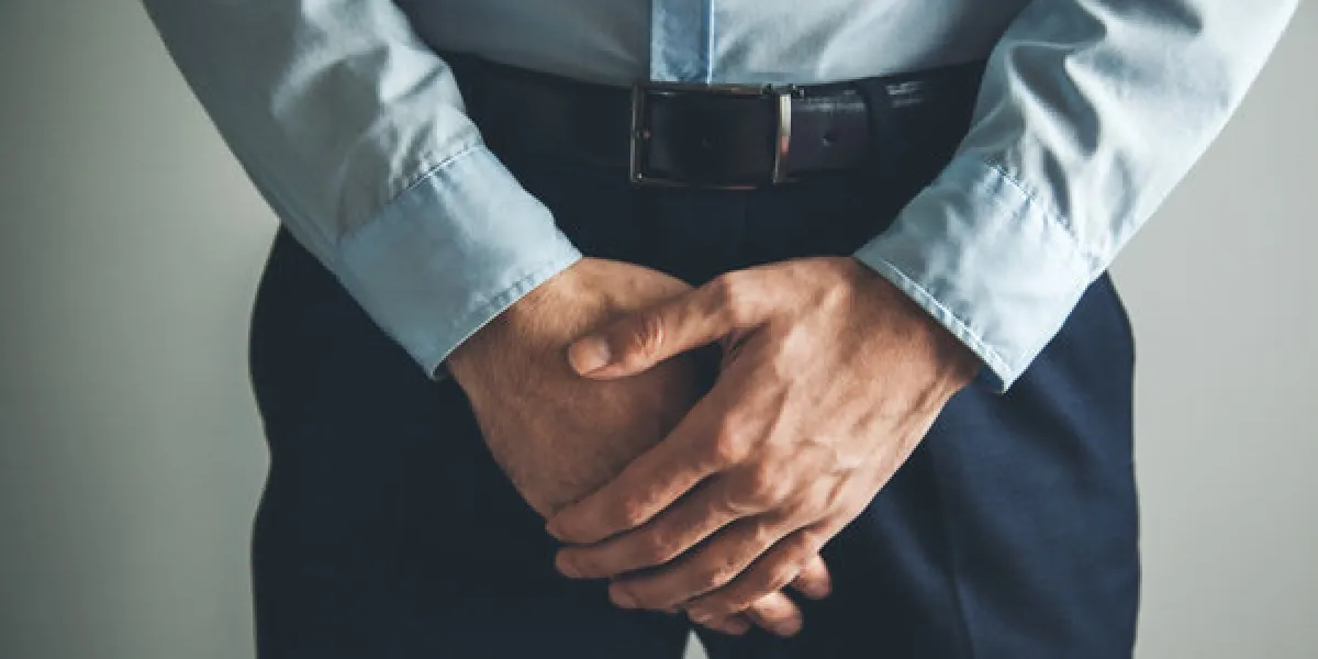 man with hands holding his crotch man with hands holding his crotch