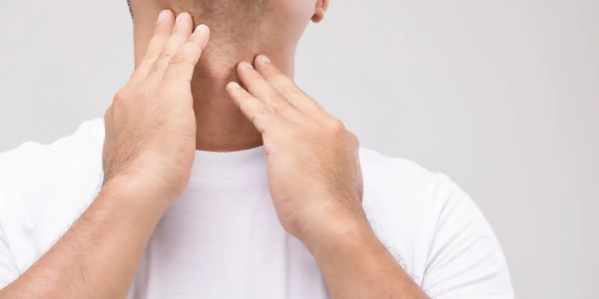 lymphoma in men concept portrait asian man is touching on his neck at lymph node position studio shot isolated on grey background lymphoma in men concept portrait asian man is touching on his neck at lymph node position studio shot isolated on grey background