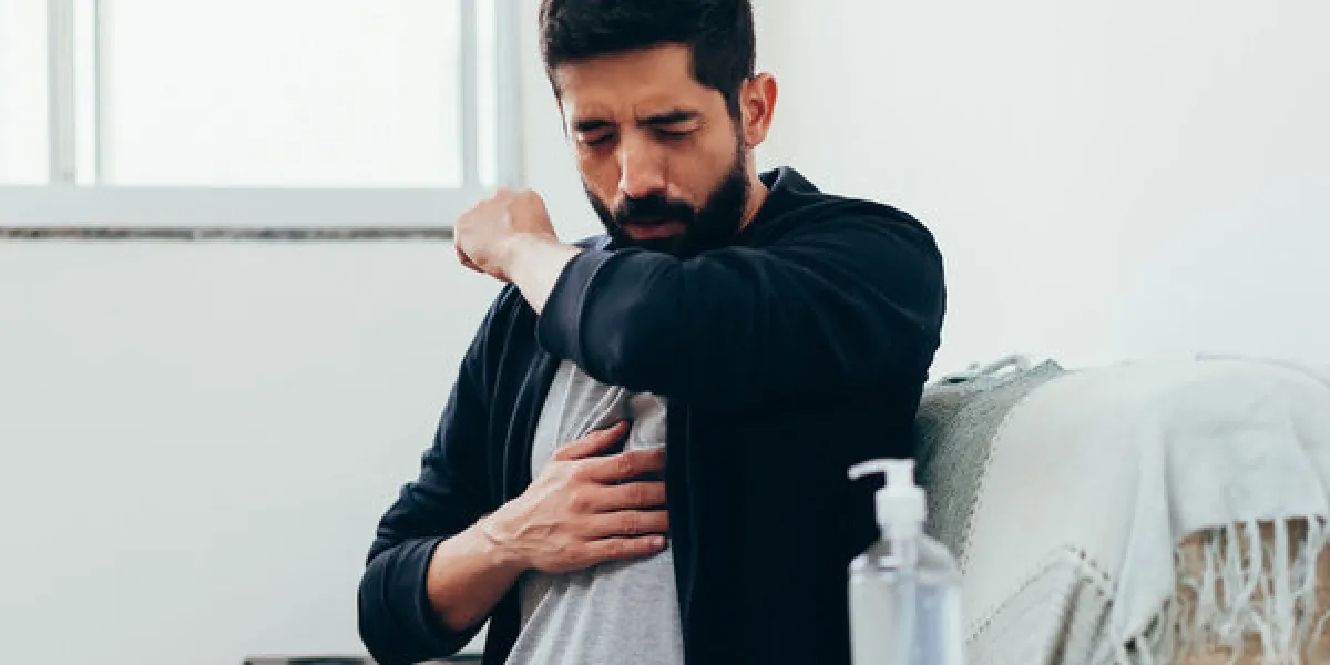 sick man coughing in his arm joint to avoid spreading coronavirus covid-19 sick man coughing in his arm joint to avoid spreading coronavirus covid-19