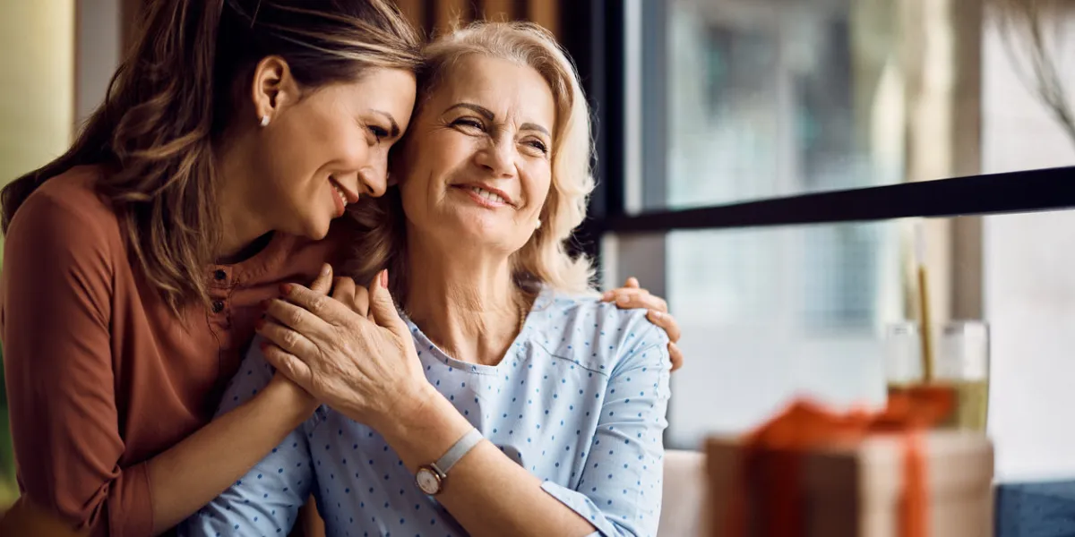 happy senior woman enjoying in daughter's affection on mother's day happy senior woman enjoying in daughter's affection on mother's day