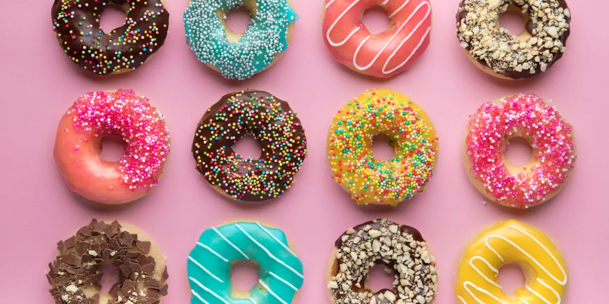 colorful sweet background delicious glazed donuts on pink background colorful sweet background delicious glazed donuts on pink background