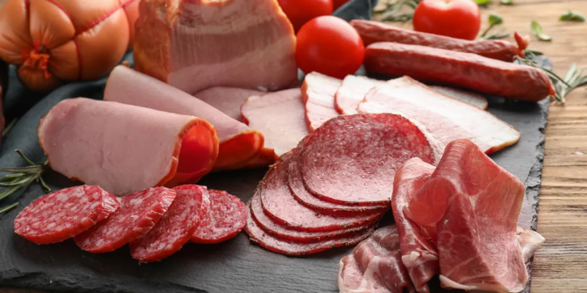 assortment of delicious deli meats on slate plate
