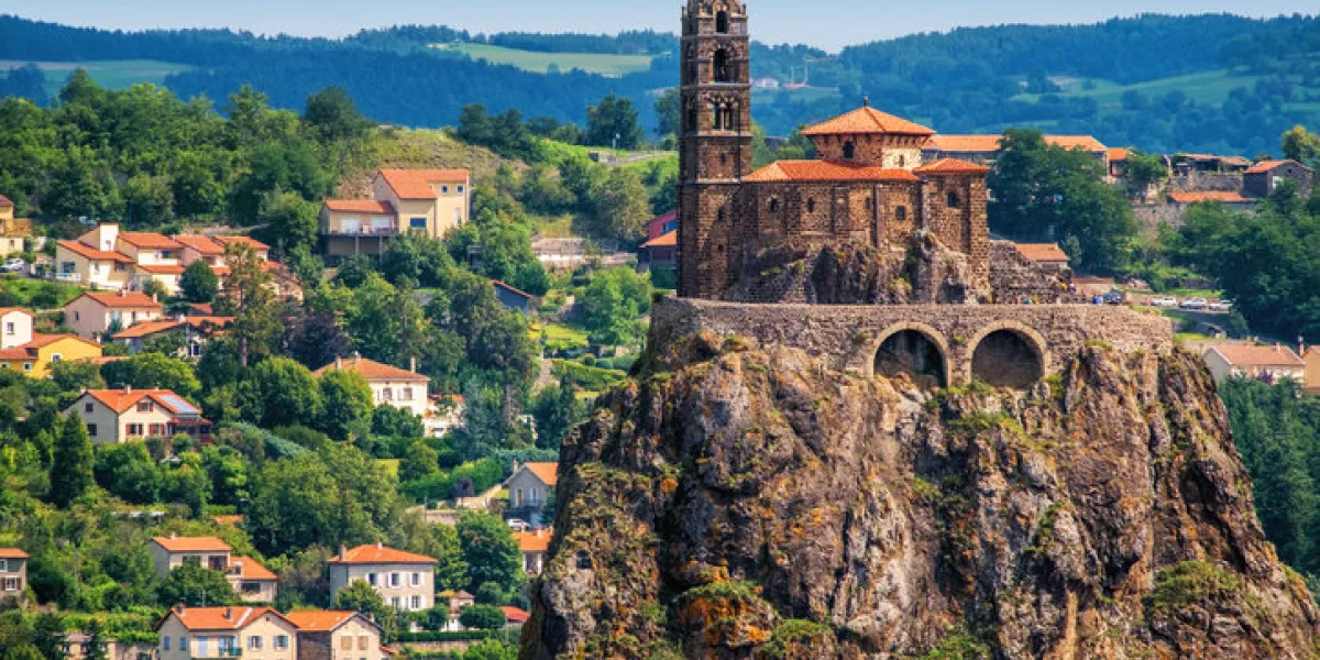 saint michel d'aiguilhe chapel sitting on a rock in le puy en velay, france saint michel d'aiguilhe chapel sitting on a rock in le puy en velay, france