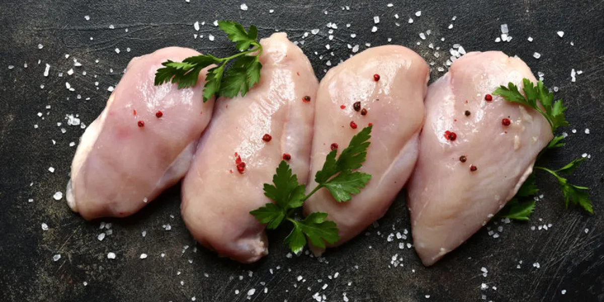 raw organic chicken breast on a dark slate, stone, concrete or metal backgroundtop view with copy space raw organic chicken breast on a dark slate, stone, concrete or metal backgroundtop view with copy space