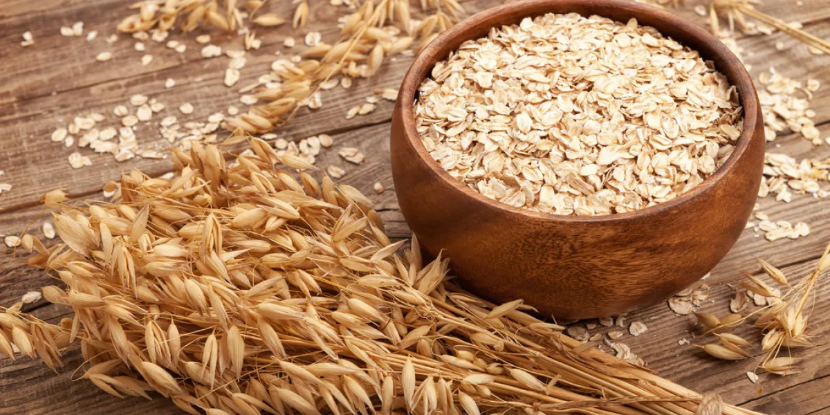 oat flakes in a bowl on the old board