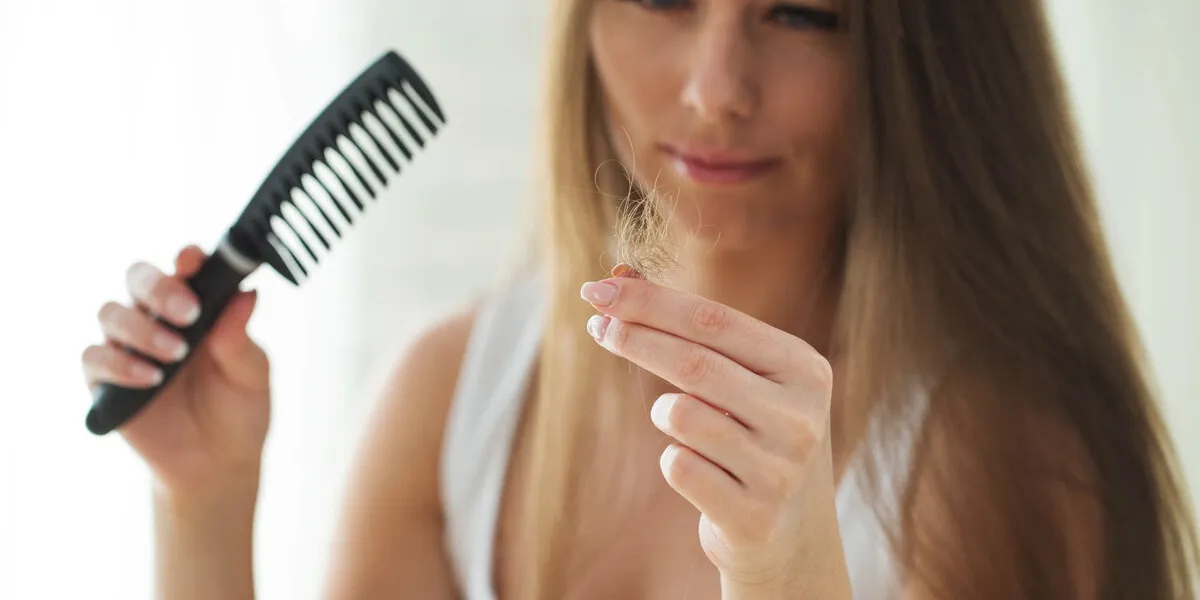 woman suffers from hair loss woman suffers from hair loss
