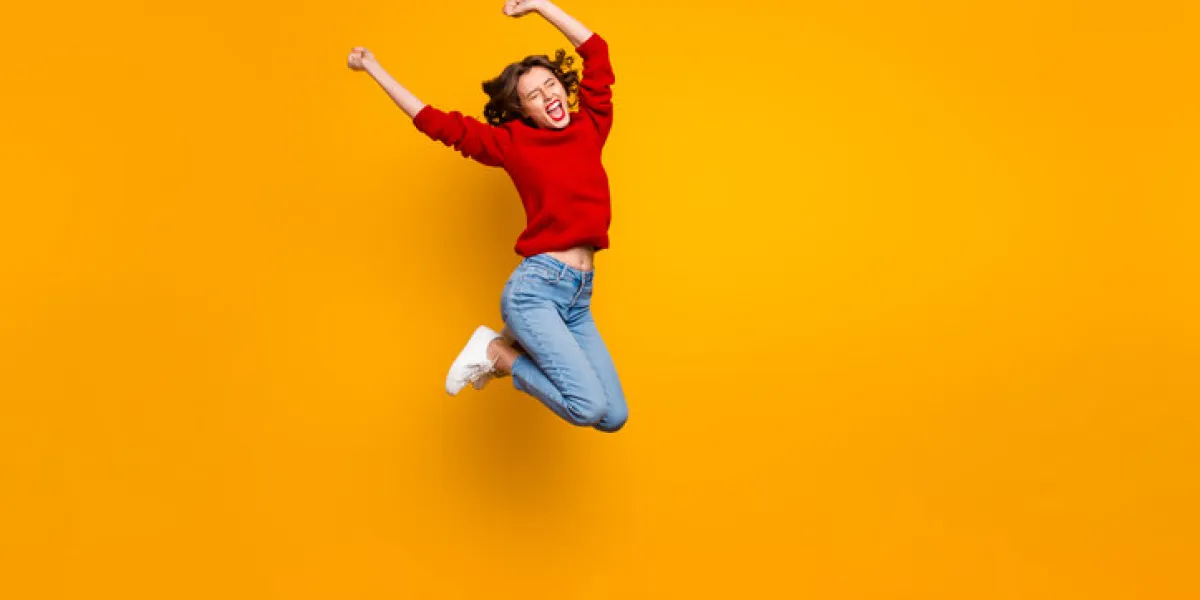 full body photo of excited lady jumping high best football fan wear, knitted pullover isolated yellow background full body photo of excited lady jumping high best football fan wear, knitted pullover isolated yellow background