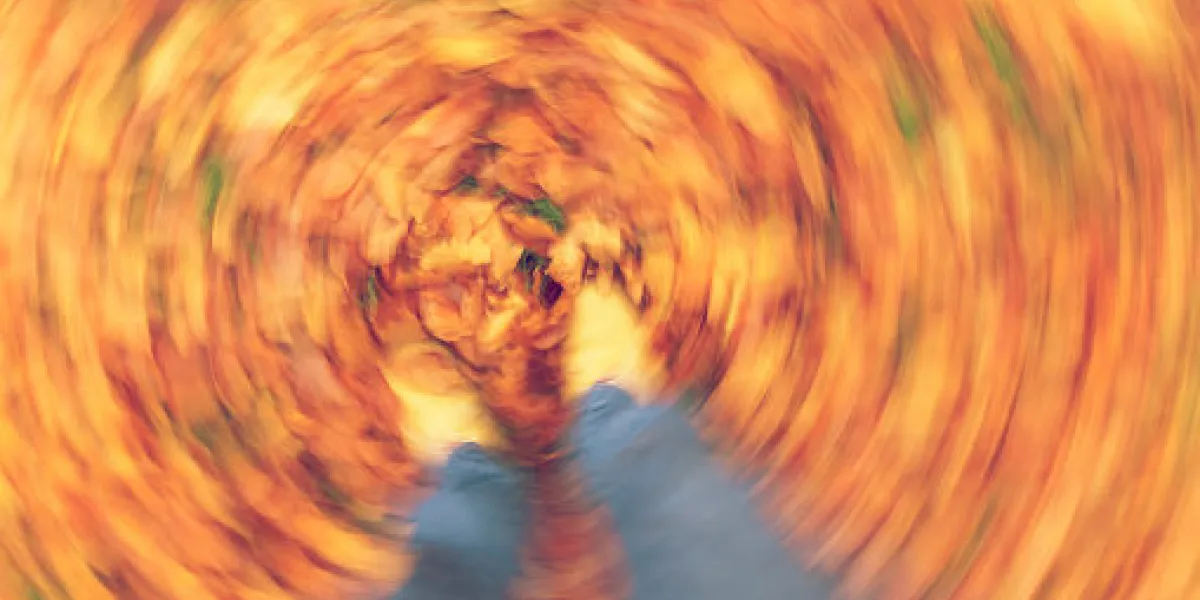motion blurred photograph of man or woman's feet walking through golden fall or autumn leaves motion blurred photograph of man or woman's feet walking through golden fall or autumn leaves