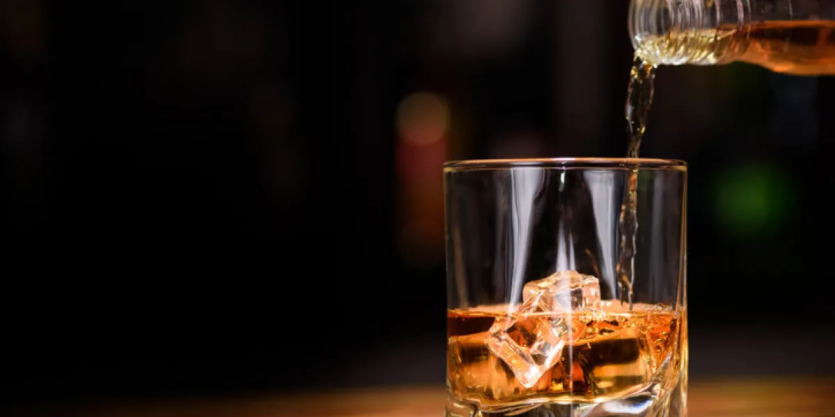 still life pour or whiskey in to glass