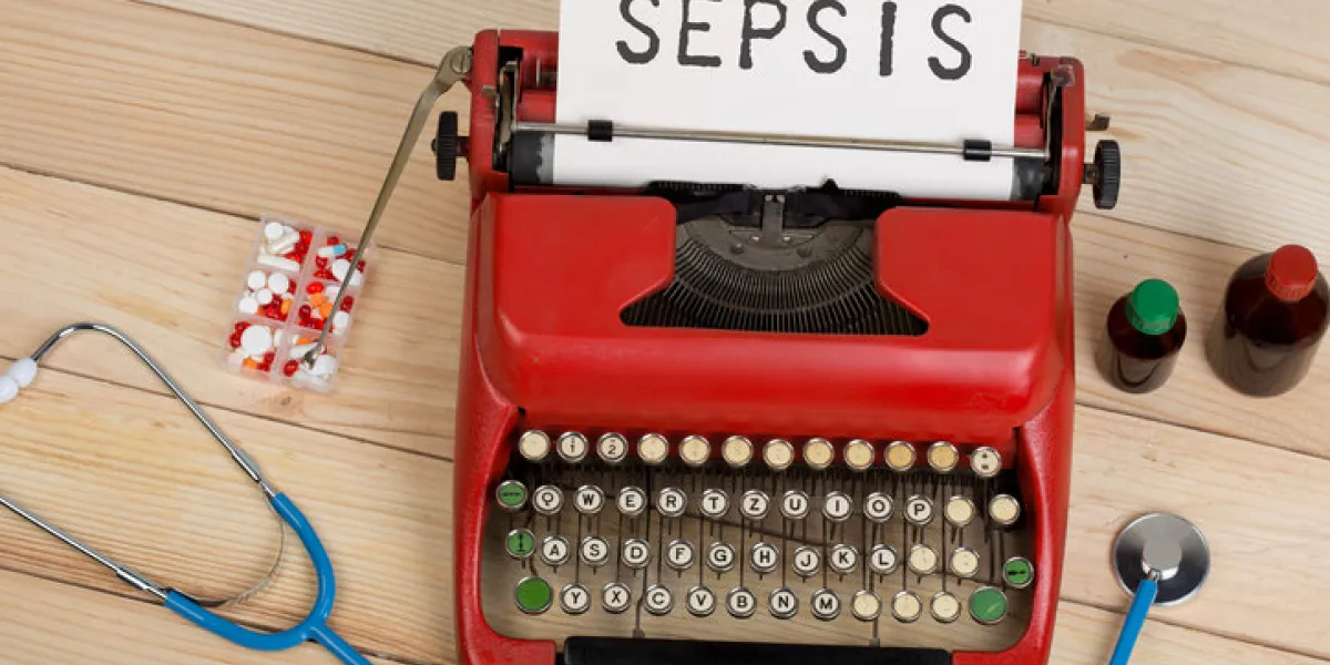 prescription medicine or medical diagnosis - doctor workplace with blue stethoscope, pills, red typewriter with text sepsis on wooden table prescription medicine or medical diagnosis - doctor workplace with blue stethoscope, pills, red typewriter with text sepsis on wooden table