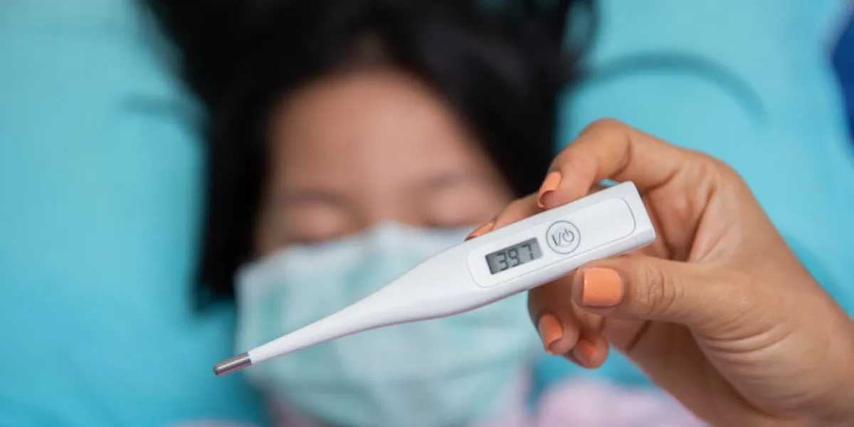 close-up mother hand holding thermometer taking child's temperature close-up mother hand holding thermometer taking child's temperature